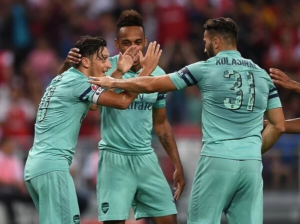 Arsenal's Ozil and Kolasinac Celebrate Goal Against Paris Saint-Germain, 2018