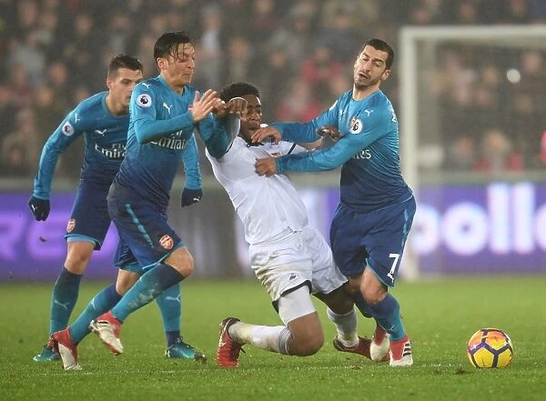 Arsenal's Ozil and Mkhitaryan Go Head-to-Head against Leroy Fer during Swansea Match