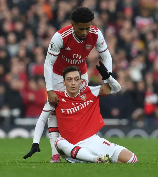 Framed Print : Arsenal's Ozil and Nelson: A Moment of Support Amidst Arsenal vs. Chelsea Rivalry (2019-20) Framed Print : Arsenal's Ozil and Nelson: A Moment of Support Amidst Arsenal vs. Chelsea Rivalry (2019-20)