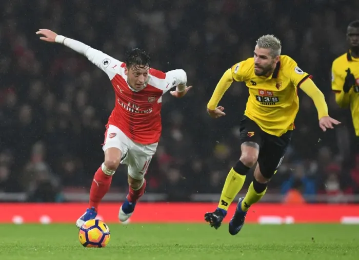 Framed Print : Arsenal's Ozil Outmaneuvers Watford's Behrami in Premier League Clash Framed Print : Arsenal's Ozil Outmaneuvers Watford's Behrami in Premier League Clash