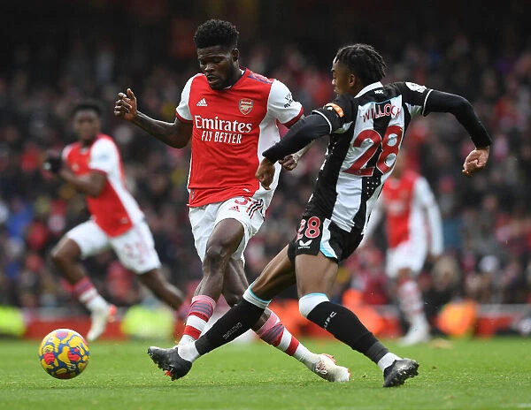 Arsenal's Partey Fends Off Willock in Intense Arsenal v Newcastle Clash