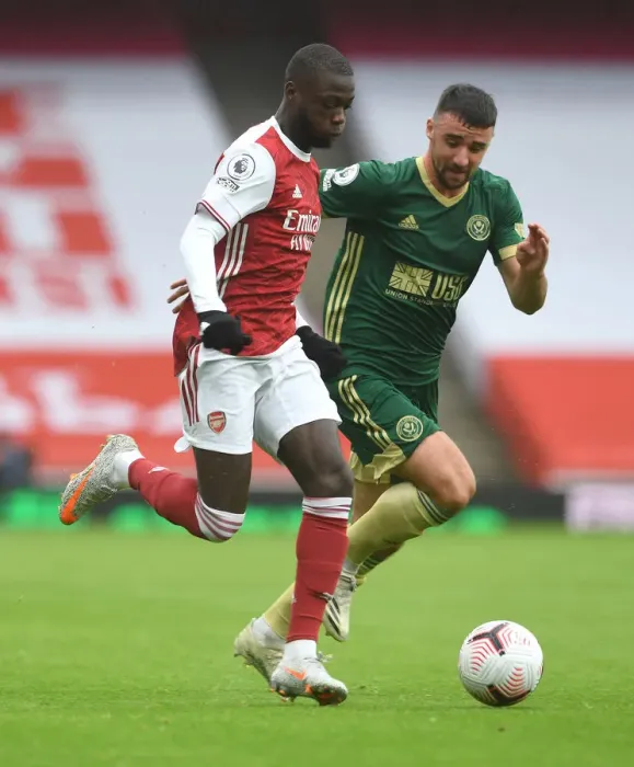 Framed Print : Arsenal's Pepe Clashes with Stevens in Premier League Showdown: Arsenal v Sheffield United (2020-21)