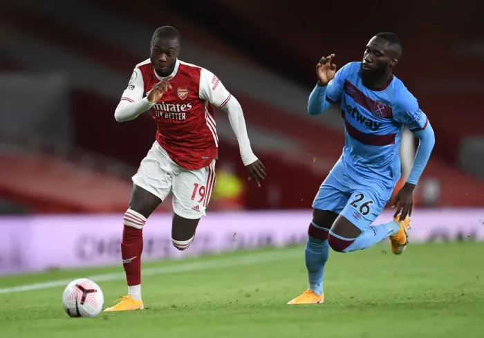 Framed Print : Arsenal's Pepe Clashes with West Ham's Masuaka in Premier League Showdown