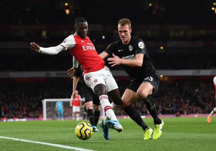 Framed Print : Arsenal's Pepe Faces Off Against Brighton's Burn in Premier League Clash