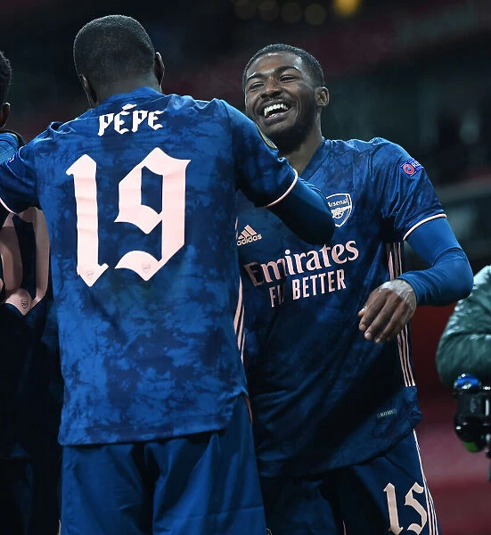 Arsenal's Pepe and Maitland-Niles Celebrate Goals Against Rapid Wien in Empty Emirates Stadium, UEFA Europa League 2020-21
