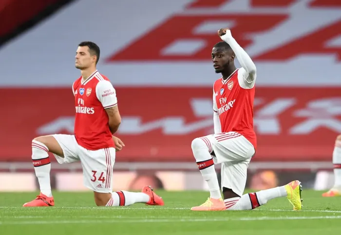Framed Print : Arsenal's Pepe Takes a Knee at Empty Emirates: Arsenal FC vs Liverpool FC, Premier League 2019-2020