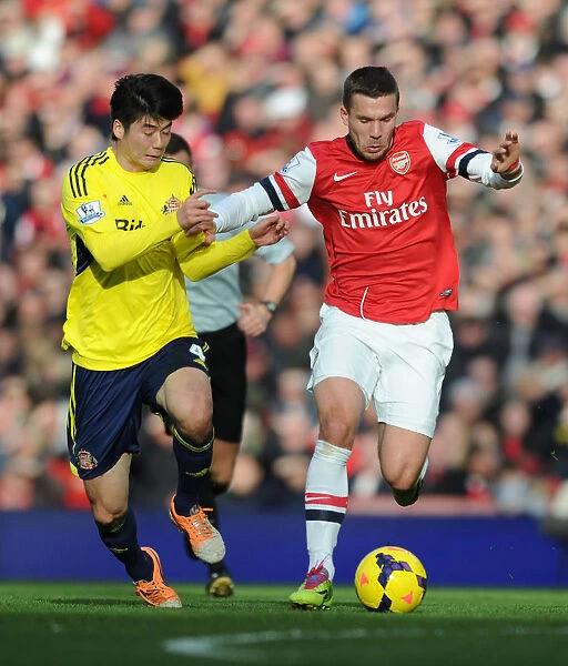 Arsenal's Podolski Clashes with Sunderland's Ki in Premier League Showdown