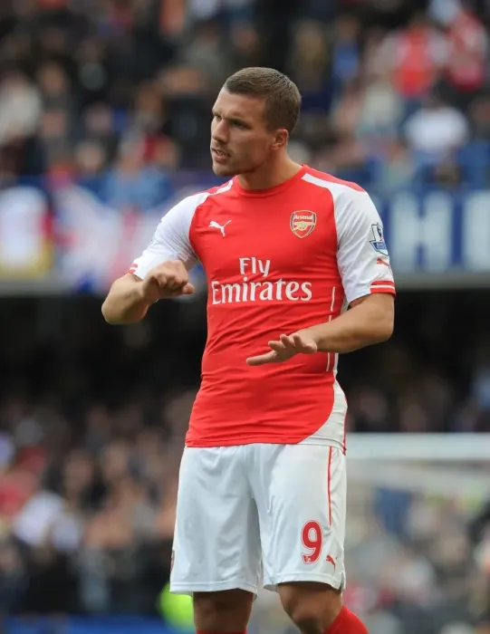 Framed Print : Arsenal's Podolski Faces Off Against Chelsea at Stamford Bridge (2014-15 Premier League)