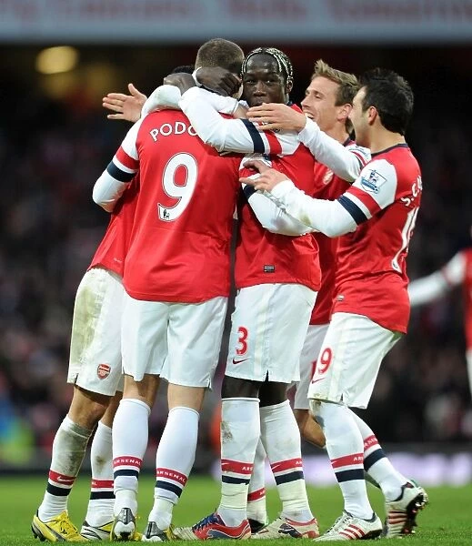 Arsenal's Podolski, Sagna, and Cazorla Celebrate Goal Against Stoke City (2013)