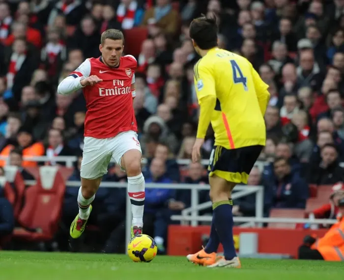 Framed Print : Arsenal's Podolski Takes On Sunderland's Ki in Premier League Clash