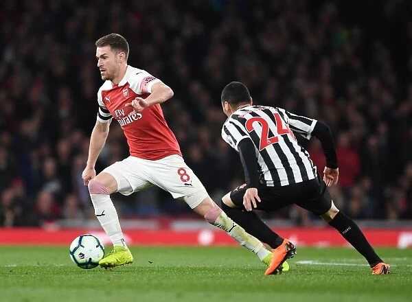 Arsenal's Ramsey Battles Almiron in Intense Arsenal v Newcastle Premier League Clash