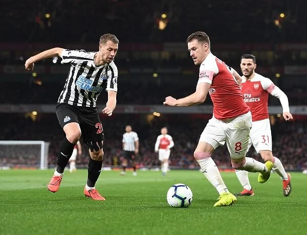 Arsenal's Ramsey Battles Lejeune in Intense Arsenal v Newcastle Premier League Clash