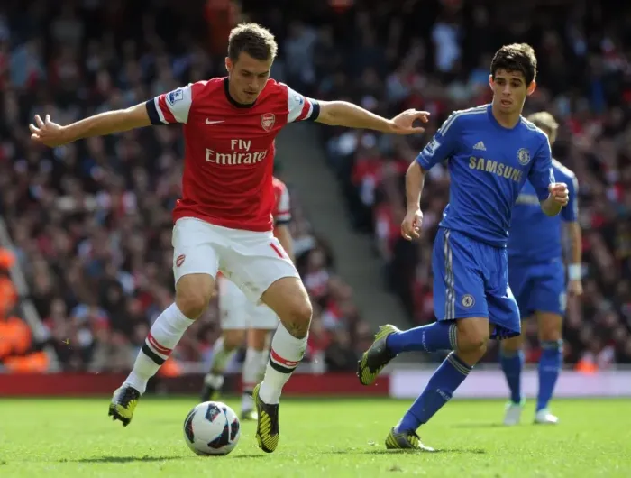 Framed Print : Arsenal's Ramsey Clashes with Chelsea's Oscar in Premier League Showdown