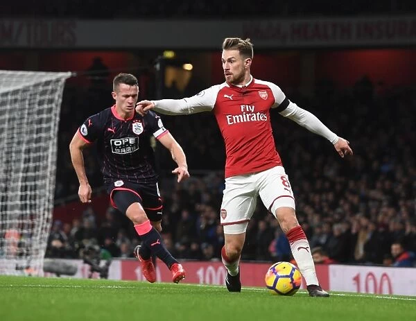Arsenal's Ramsey Clashes with Huddersfield's Hogg in Premier League Showdown