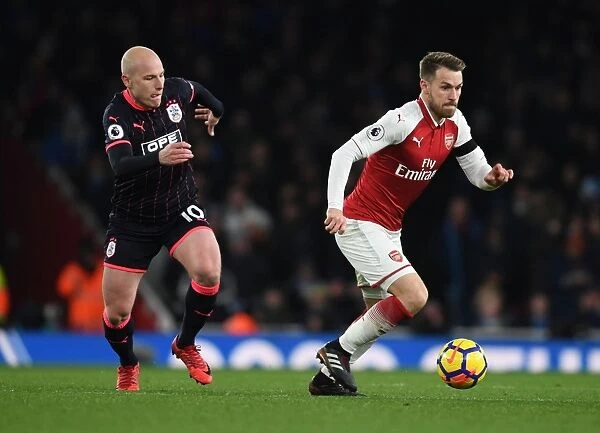Arsenal's Ramsey Clashes with Huddersfield's Mooy in Premier League Showdown