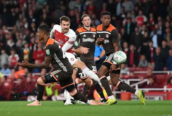 Framed Print : Arsenal's Ramsey Faces Off Against Brentford's Jeanvier in Carabao Cup Clash