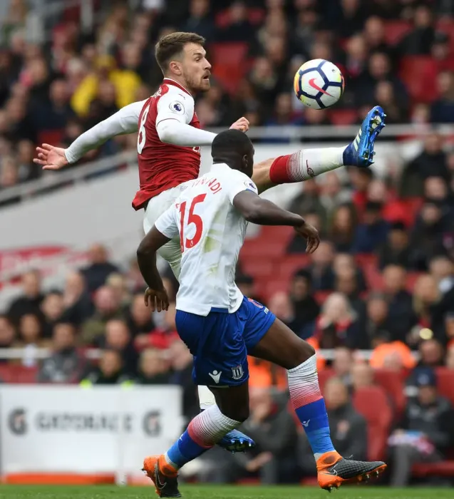 Framed Print : Arsenal's Ramsey Faces Off Against Stoke's Martin Indi in Intense Premier League Clash