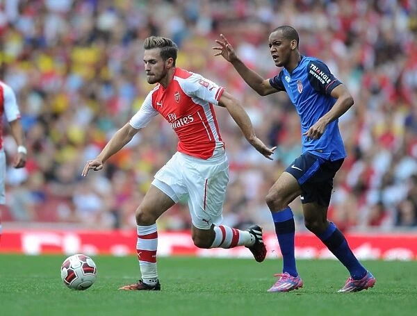 Arsenal's Ramsey Outmaneuvers Monaco's Fabinho in Emirates Cup Clash