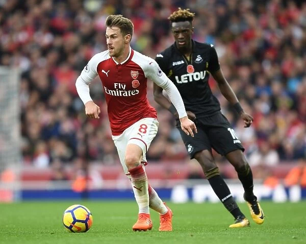 Arsenal's Ramsey Outmaneuvers Swansea's Abraham in Premier League Clash