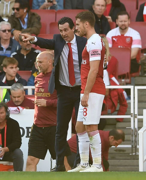 Arsenal's Ramsey Receives Instructions from Emery during Arsenal v Watford Match