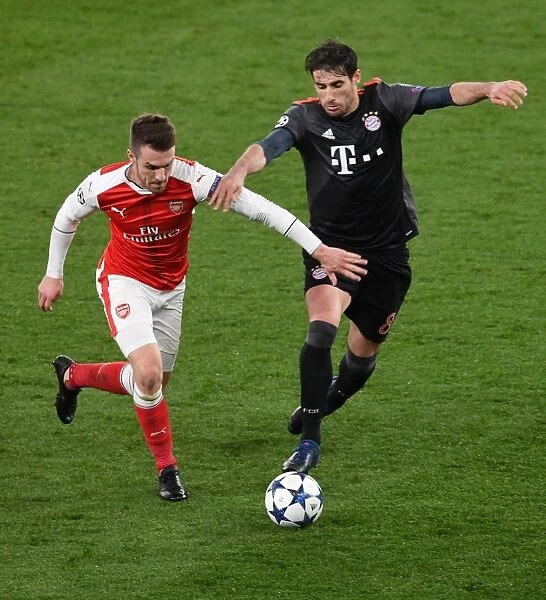 Arsenal's Ramsey Stands Firm Against Bayern's Martinez in Champions League Clash