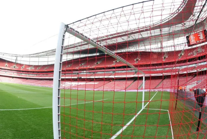 Framed Print : Arsenal's Red Nike Goalnets: Lace Up Save Lives in Action during Manchester United Match