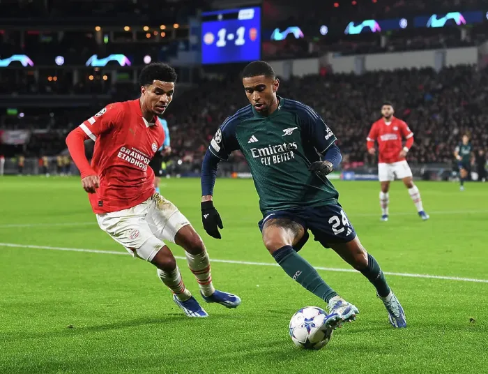 Framed Print : Arsenal's Reiss Nelson Faces Off Against PSV's Malik Tillman in Champions League Clash Framed Print : Arsenal's Reiss Nelson Faces Off Against PSV's Malik Tillman in Champions League Clash