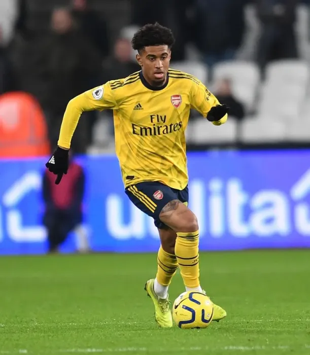 Framed Print : Arsenal's Reiss Nelson Faces Off Against West Ham in Premier League Clash