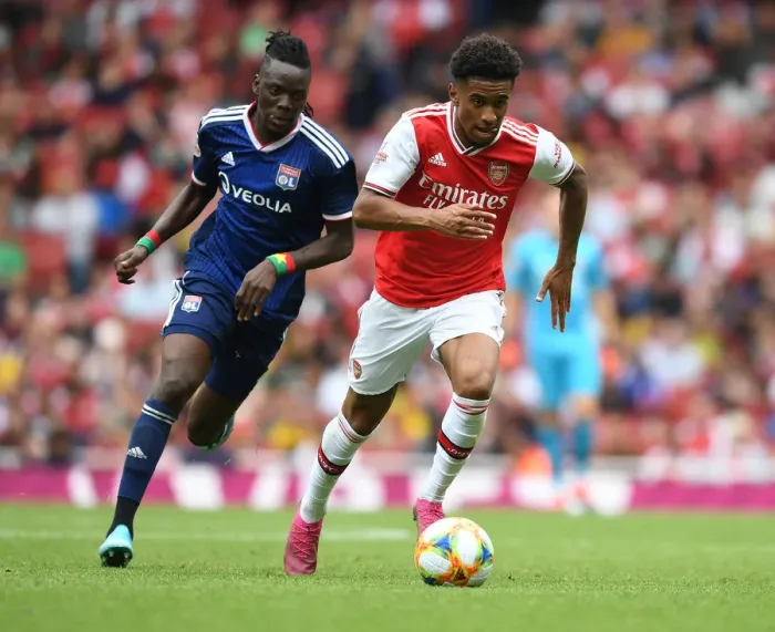 Framed Print : Arsenal's Reiss Nelson Outmaneuvers Lyon's Bertrand Traore at Emirates Cup Framed Print : Arsenal's Reiss Nelson Outmaneuvers Lyon's Bertrand Traore at Emirates Cup