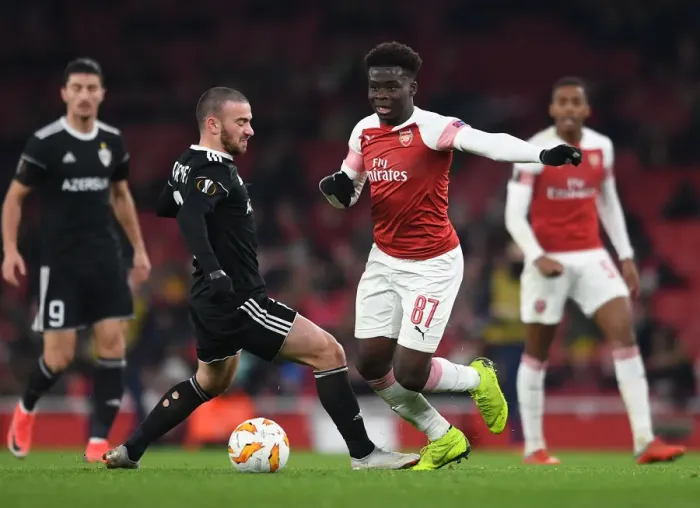 Framed Print : Arsenal's Rising Star Bukayo Saka Goes Head-to-Head with Qarabag's Defender Gara Gareyev in Europa League Showdown