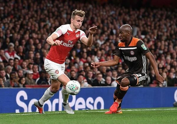 Arsenal's Rob Holding Clashes with Brentford's Moses Odubajo in Carabao Cup Showdown