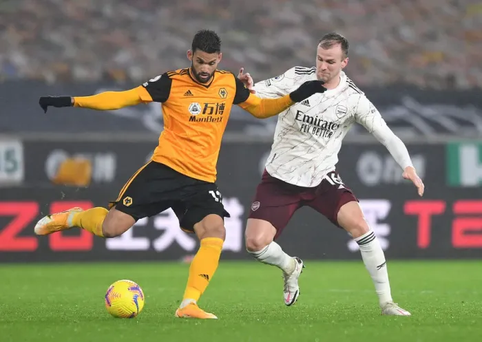 Framed Print : Arsenal's Rob Holding Closes In on Wolverhampton's Willian Jose in Intense Premier League Clash