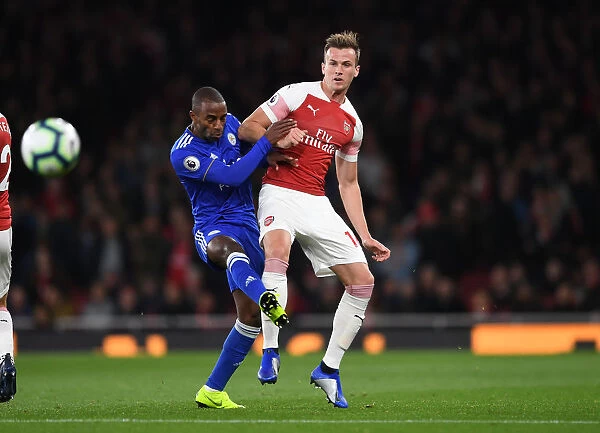 Arsenal's Rob Holding Fends Off Leicester's Ricardo Pereira in Intense Premier League Clash
