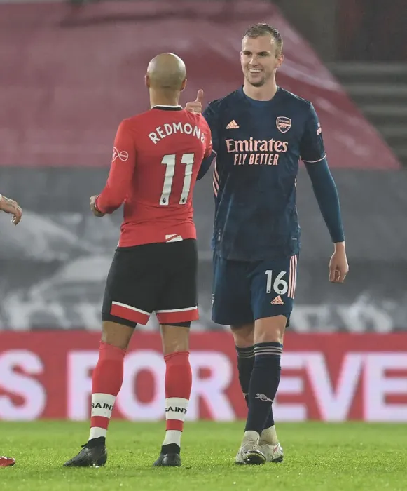 Framed Print : Arsenal's Rob Holding and Southampton's Nathan Redmond Exchange Handshakes in Empty St. Mary's Stadium - Southampton vs Arsenal, 2021 Premier League