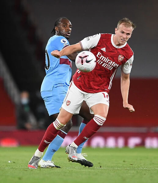 Arsenal's Rob Holding Wins the Ball from West Ham's Michail Antonio in 2020-21 Premier League Clash