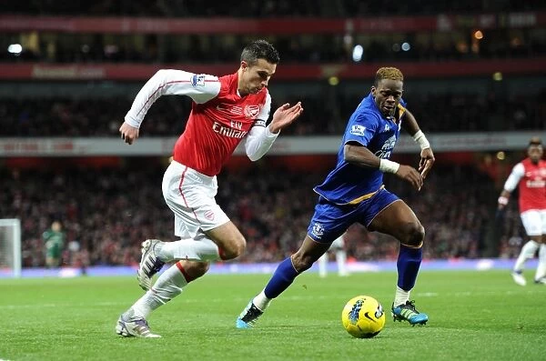 Arsenal's Robin van Persie Clashes with Everton's Louis Saha during the 2011-12 Premier League Match
