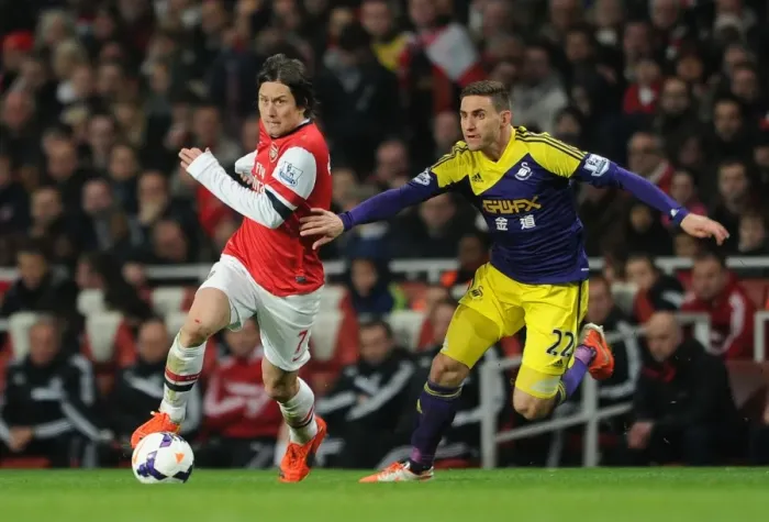 Framed Print : Arsenal's Rosicky Clashes with Swansea's Rangel in Premier League Showdown
