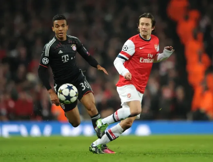 Framed Print : Arsenal's Rosicky Evades Bayern's Gustavo in Champions League Clash