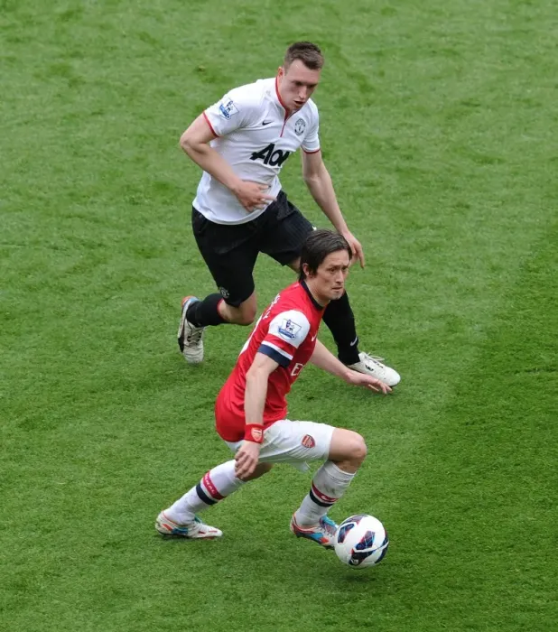 Framed Print : Arsenal's Rosicky Faces Off Against Manchester United's Jones: A Premier League Showdown