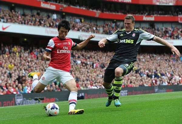 Arsenal's Ryo Miyaichi Faces Off Against Stoke's Robert Huth