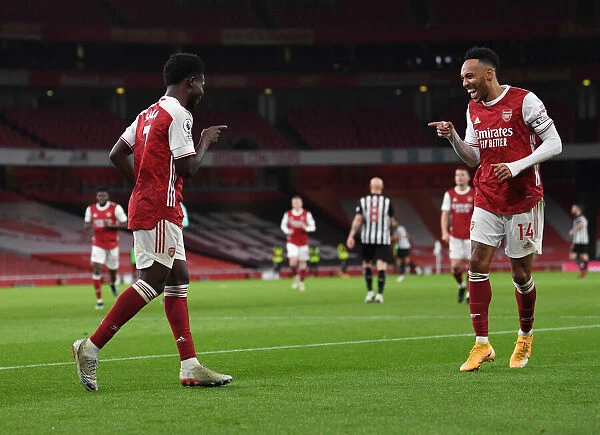Arsenal's Saka and Aubameyang Celebrate Goals in Empty Emirates Stadium Against Newcastle United (2021)