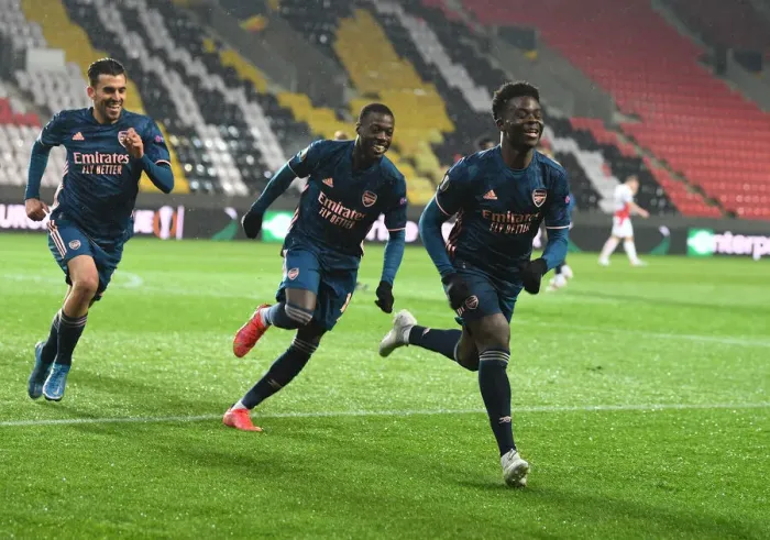 Framed Print : Arsenal's Saka, Ceballos, and Pepe: Empty Eden Arena Goal Celebrations during UEFA Europa League Quarterfinals