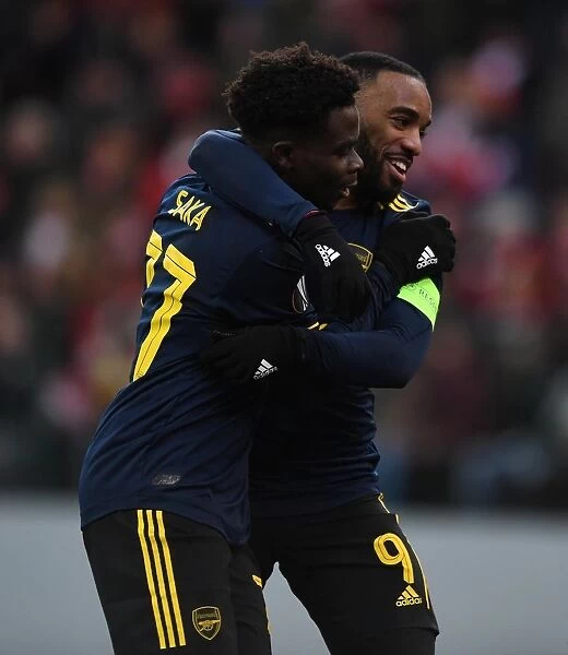 Arsenal's Saka and Lacazette: Celebrating Goals in Europa League Victory over Standard Liege