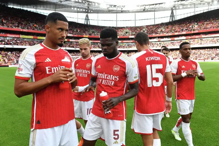 Framed Print : Arsenal's Saliba and Partey Share a Moment Before Arsenal FC vs AS Monaco (2023-24 Emirates Cup)