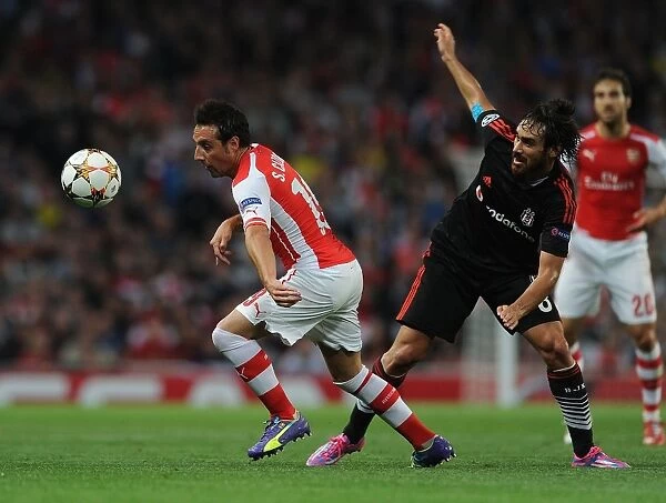 Arsenal's Santi Cazorla Battles Past Besiktas Veli Kavlak in UEFA Champions League Qualifier