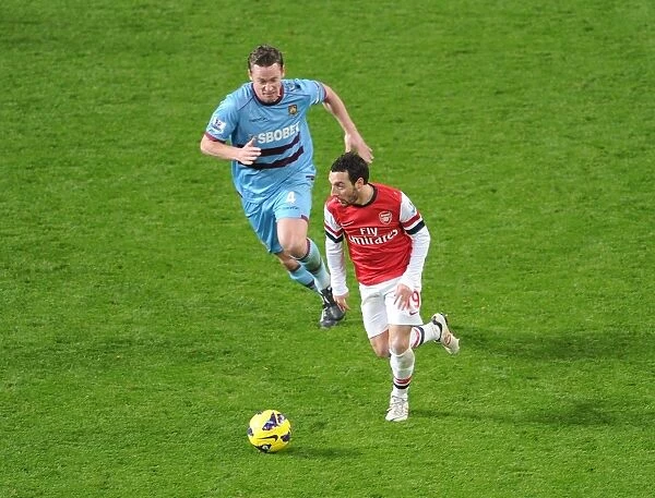 Arsenal's Santi Cazorla Clashes with West Ham's Kevin Nolan during the Premier League Match