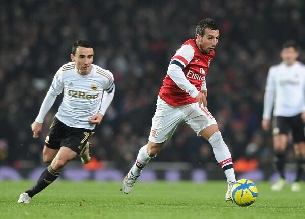 Arsenal's Santi Cazorla Dashes Past Swansea's Leon Britton in FA Cup Third Round Replay