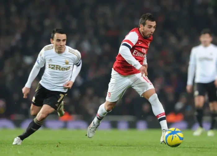 Framed Print : Arsenal's Santi Cazorla Dashes Past Swansea's Leon Britton in FA Cup Third Round Replay Framed Print : Arsenal's Santi Cazorla Dashes Past Swansea's Leon Britton in FA Cup Third Round Replay