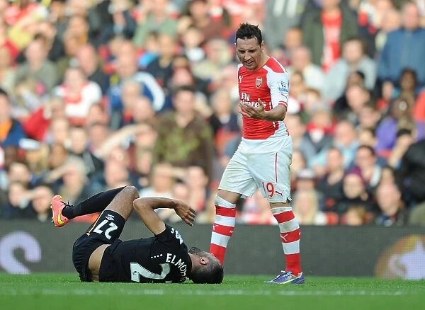 Arsenal's Santi Cazorla Faces Off Against Hull's Ahmed Elmohamady during the 2014-15 Premier League Match