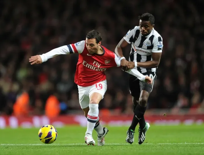 Framed Print : Arsenal's Santi Cazorla Faces Off Against Newcastle's Gael Bigirimana in Premier League Clash Framed Print : Arsenal's Santi Cazorla Faces Off Against Newcastle's Gael Bigirimana in Premier League Clash